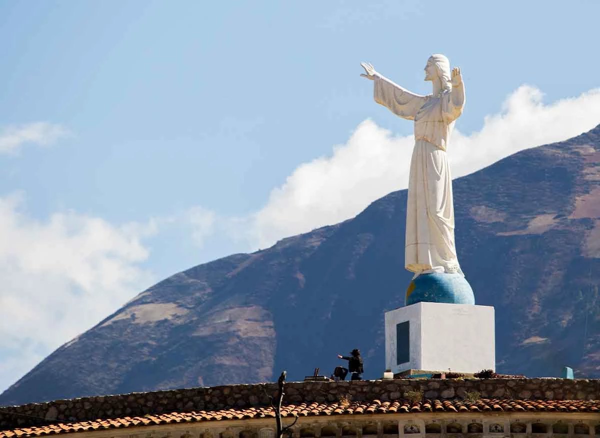 Monumental Christ of Yungay with arms extended over the valley