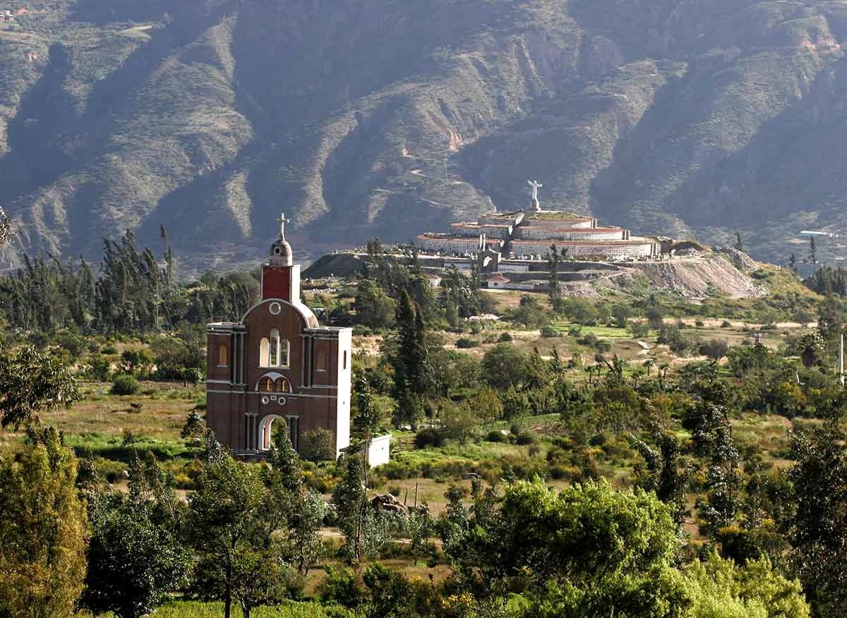 Landscape of the memorial with the old church replica and cemetery